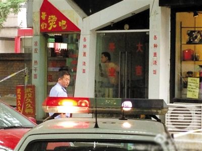 闖入面館的持刀男子與趕來的民警隔著玻璃門對(duì)峙，后店內(nèi)一名女童被其劫持。網(wǎng)友供圖