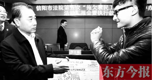 張立勇將依法執(zhí)行回來的農(nóng)民工工資發(fā)放給案件當(dāng)事人游昌華，游昌華施以中國傳統(tǒng)作揖禮答謝