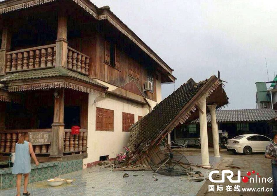 當(dāng)?shù)貢r(shí)間2014年5月5日，泰國清萊，一名婦女看著受損的房屋。 圖片來源：東方IC