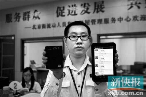 　越秀區(qū)北京街出租屋外來暫住人員管理服務(wù)中心的工作人員展示到出租屋登記來穗人員信息的儀器。