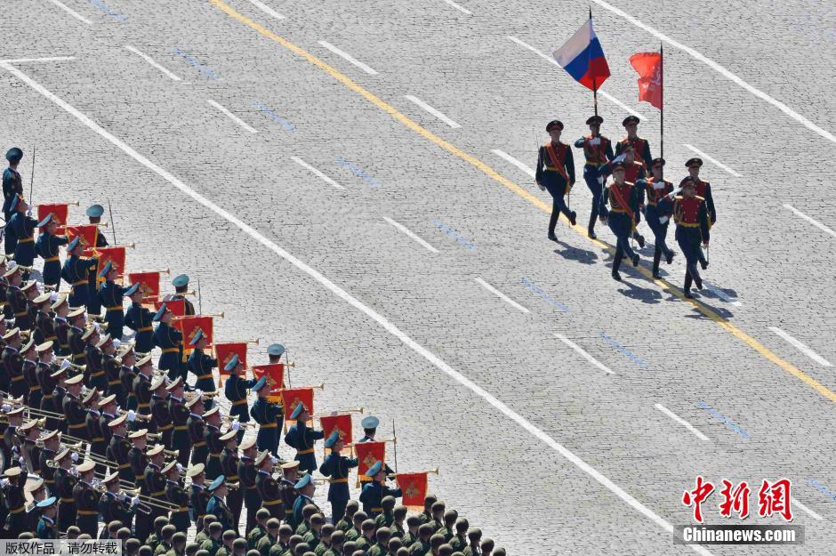 圖為俄羅斯國旗從受閱部隊(duì)前經(jīng)過。